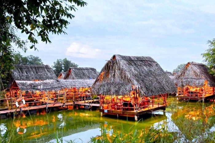 Thatched huts on the lake in Long Trung Ecotourism Area